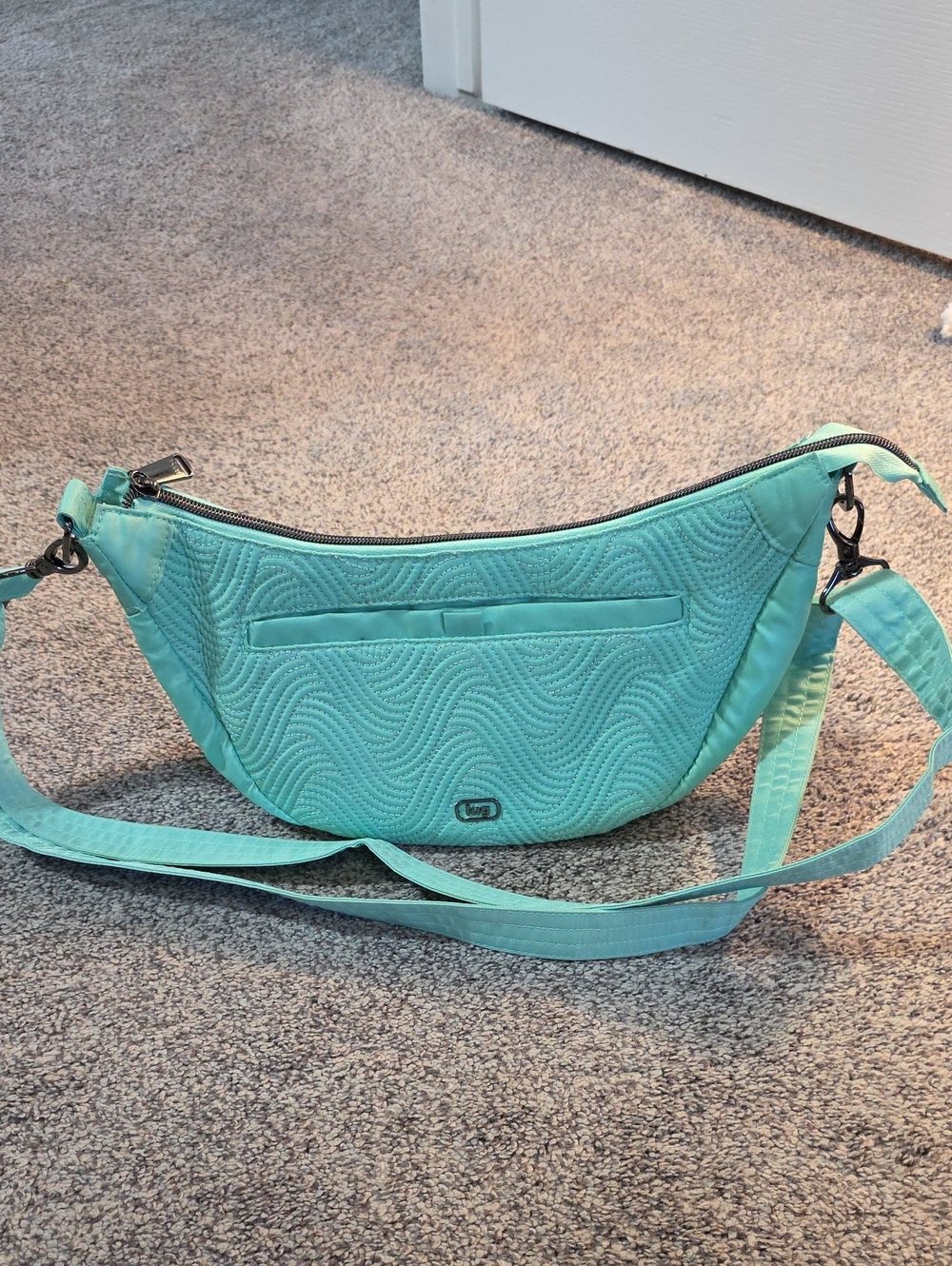 lug Swish Quilted Crossbody Bag in seaglass green colour with flamingo 🦩interior
